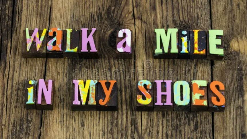 Image with colorful words spelling out the phrase 'Walk a mile in my shoes'
