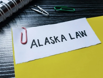 Image of a yellow folder with a note paperclipped to the front that reads, 'Alaska Law'